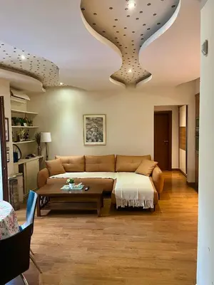 a living room with a couch and a table at Step to the sea apartment in Rafailovici