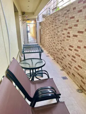two tables and chairs in a room with a brick wall at Step to the sea apartment in Rafailovici
