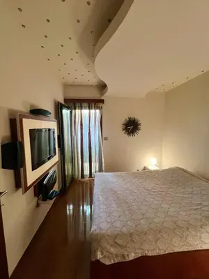 a bedroom with a bed and a flat screen tv at Step to the sea apartment in Rafailovici