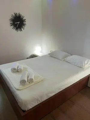 a bed with two towels and two pillows on it at Step to the sea apartment in Rafailovici