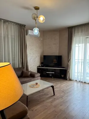 a living room with a couch and a table at Enjoy 1 Apartmani in Podgorica