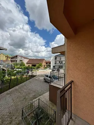 a balcony with a car parked in a parking lot at Enjoy 1 Apartmani in Podgorica