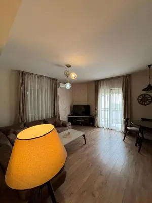 a living room with a couch and a table at Enjoy 1 Apartmani in Podgorica