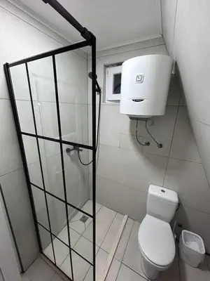 a bathroom with a toilet and a shower at Cozzy LUX apartment near the Airport Podgorica in Lajkovići