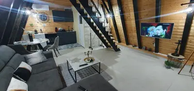 a living room with a couch and a tv at Cozzy LUX apartment near the Airport Podgorica in Lajkovići