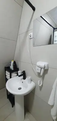 a bathroom with a white sink and a mirror at Cozzy LUX apartment near the Airport Podgorica in Lajkovići