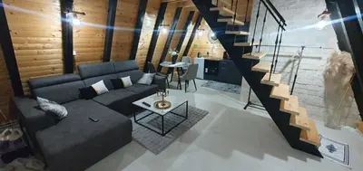 a living room with a couch and a table at Cozzy LUX apartment near the Airport Podgorica in Lajkovići