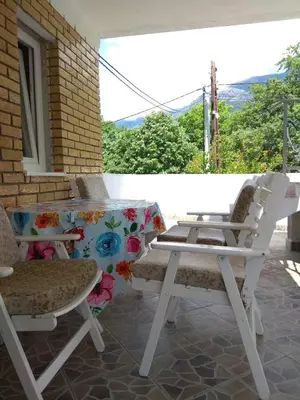 a white table and two chairs on a patio at Apartment M2 Pine tree Sutomore in Sutomore