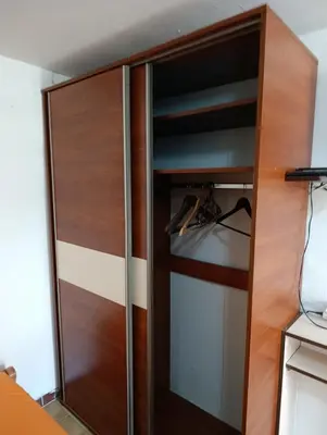 a wooden cabinet with glass doors in a room at Dvokrevetna soba, Spaso in Petrovac na Moru