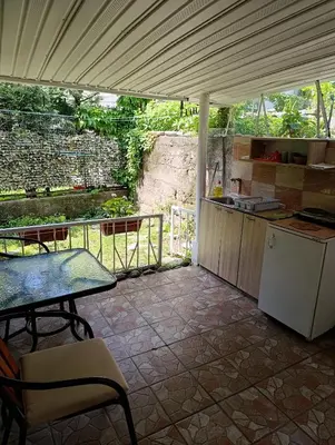 a kitchen with a table and a table and a counter at Dvokrevetna soba, Spaso in Petrovac na Moru