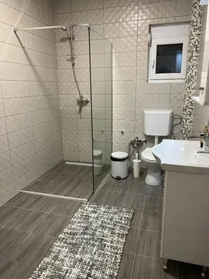 a bathroom with a shower and a toilet and a sink at Villa House Ilda in Bar