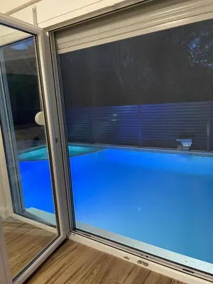 a glass window with a view of a swimming pool at Villa House Ilda in Bar