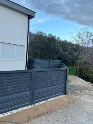 a black fence in front of a house at Villa House Ilda in Bar