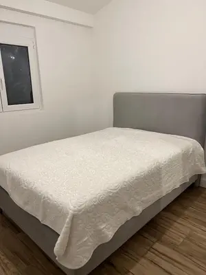 a bed in a white room with a window at Villa House Ilda in Bar
