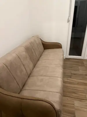 a brown couch sitting in a room next to a door at Villa House Ilda in Bar
