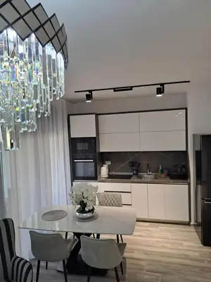 a kitchen and dining room with a table and chairs at Apartments Pepdjonovic in Ulcinj