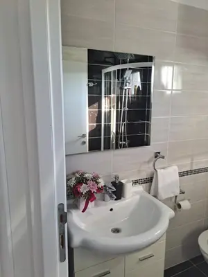 a bathroom with a white sink and a mirror at Apartments Pepdjonovic in Ulcinj