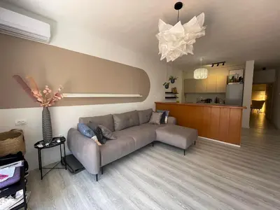 a living room with a couch and a kitchen at Apartment Sveti Stefan in Sveti Stefan