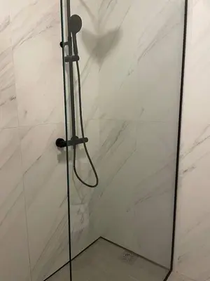 a shower with a glass door in a bathroom at Apartment Sveti Stefan in Sveti Stefan