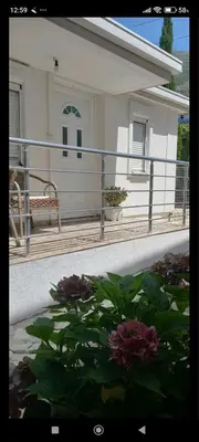 a balcony of a house with a flower garden at Apartman Olgica in Sutomore