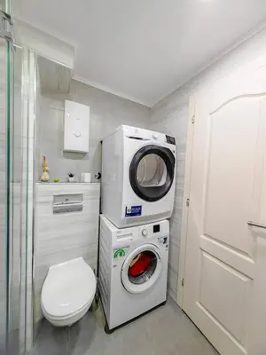 a bathroom with a washing machine and a washer at Apartman Petar-Spacious Friendly Stay in the Heart of Budva in Budva