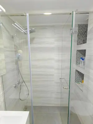a shower with a glass door in a bathroom at Apartman Petar-Spacious Friendly Stay in the Heart of Budva in Budva