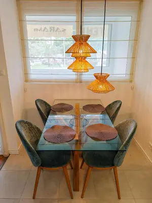 a dining room with a glass table and chairs at Apartman Petar-Spacious Friendly Stay in the Heart of Budva in Budva