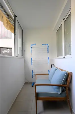 a room with a bed with blue pillows on it at Apartman Petar-Spacious Friendly Stay in the Heart of Budva in Budva