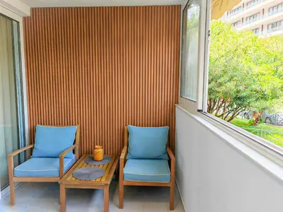 two chairs and a table in front of a window at Apartman Petar-Spacious Friendly Stay in the Heart of Budva in Budva