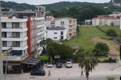 a city with cars parked in a parking lot at Ulcinj Vibes & Waves Apartment in Ulcinj