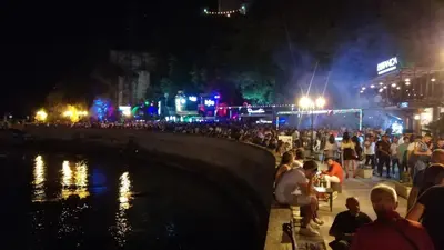 a crowd of people sitting next to a river at night at Ulcinj Vibes & Waves Apartment in Ulcinj