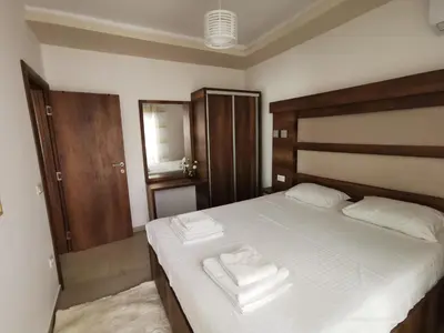 a bedroom with a bed with two towels on it at Ulcinj Vibes & Waves Apartment in Ulcinj