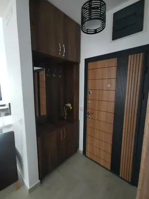 a room with two wooden cabinets and a door at Ulcinj Vibes & Waves Apartment in Ulcinj