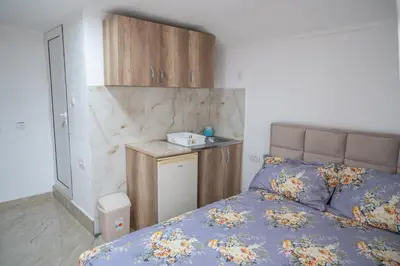a bedroom with a bed and a small counter at Apartments Hamburg in Donji Štoj