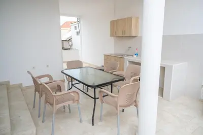 a dining room with a table and chairs in a kitchen at Apartments Hamburg in Donji Štoj