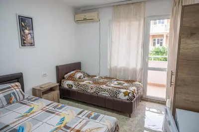 a hotel room with two beds and a window at Apartments Hamburg in Donji Štoj