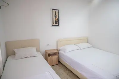 two beds in a room with white walls at Apartments Hamburg in Donji Štoj