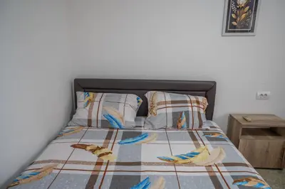 a bedroom with a bed with birds on it at Apartments Hamburg in Donji Štoj