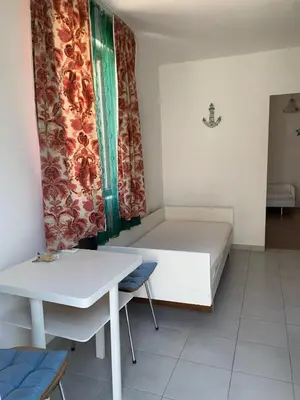 a small room with a bed and a table at Domaćinstvo Kvaić in Bar