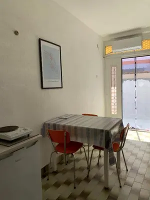 a kitchen with a table and chairs in a room at Domaćinstvo Kvaić in Bar