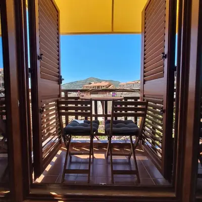 a balcony with two chairs and a view of the ocean at Apartment Shell in Budva