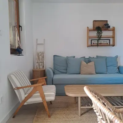 a living room with a blue couch and a table at Apartment Shell in Budva