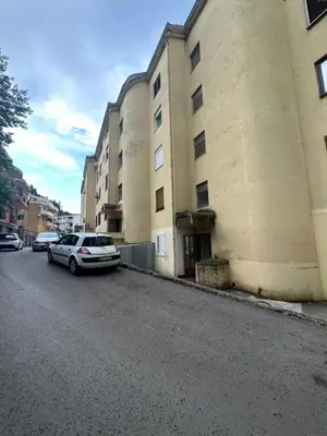 a car parked next to a building on a street at Apartment Shell in Budva