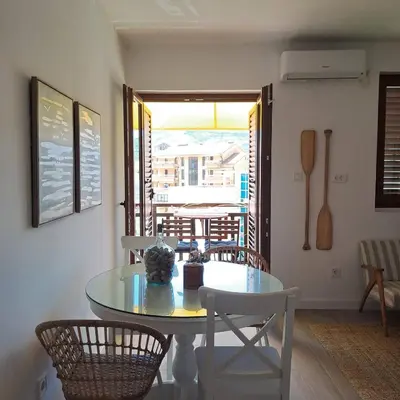 a dining room with a glass table and chairs at Apartment Shell in Budva