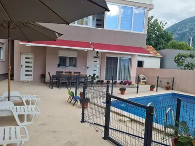 a house with a pool and chairs and an umbrella at Villa Passaggio Private Pool & Tranquil Stay Near the Sea in Bar