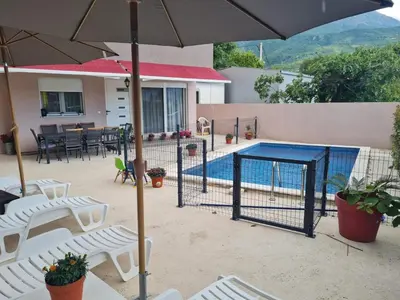 a swimming pool with chairs and an umbrella at Villa Passaggio Private Pool & Tranquil Stay Near the Sea in Bar