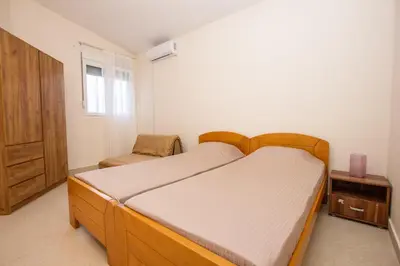 a bedroom with a bed and a chair in it at Oliva home in Utjeha