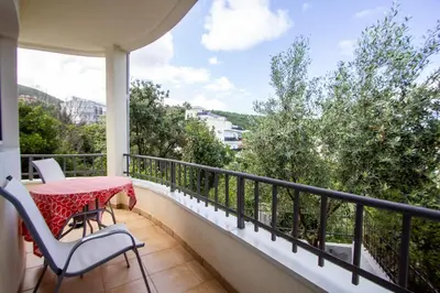 a balcony with a table and chairs and a view at Oliva home in Utjeha