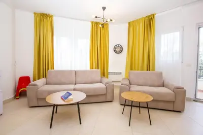 a living room with two couches and a table at Oliva home in Utjeha