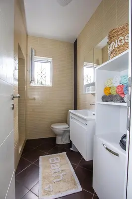 a bathroom with a toilet and a sink at Oliva home in Utjeha